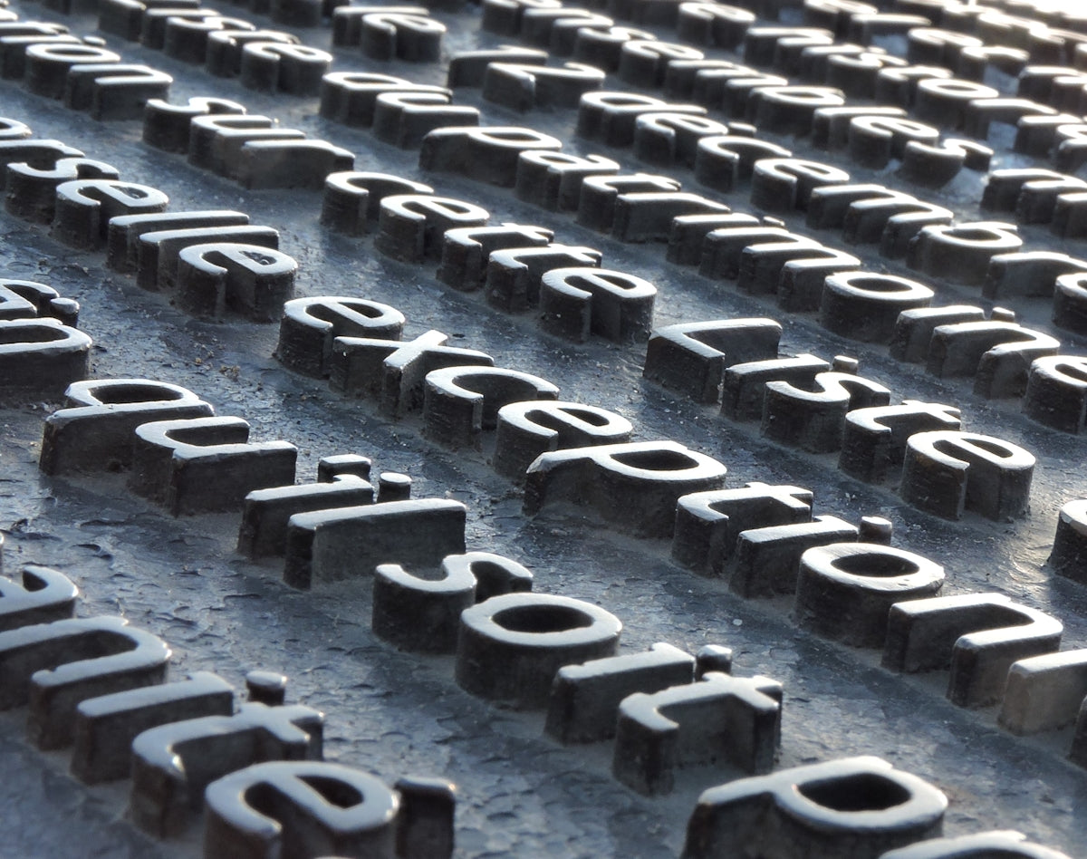 a close up of a metal surface with letters