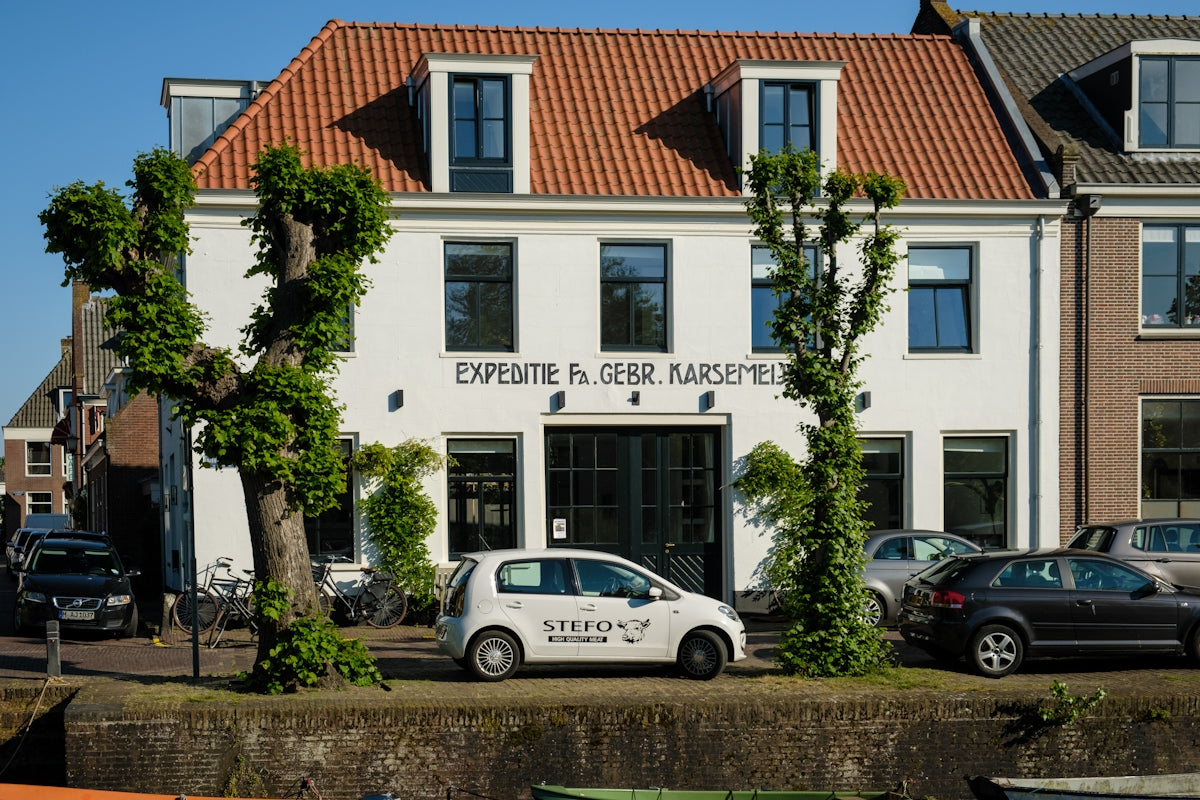 a white car parked in front of a building